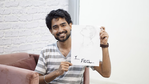 Kuldeep pant with a drawing in his hand