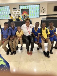 Erica McKenzie sitting with young boys - Empowering the Future