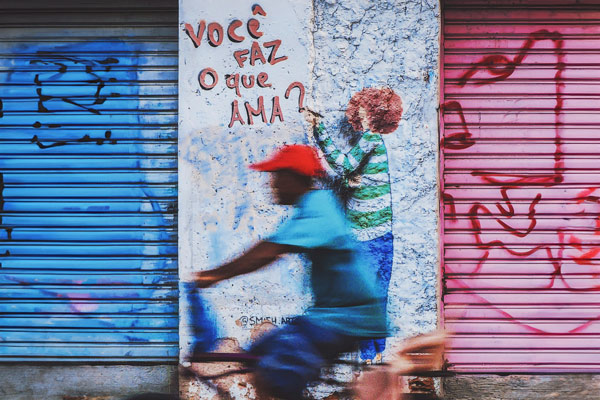 man-riding-a-bike-by-a-graffiti-on-the-wall