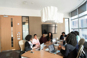 a-group-of-professional-women-sitting-down-in-a-office-setting