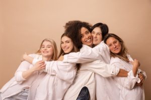 different-interage-women-white-shirts-with-unique-natural-beauty-hug-each-other-beige-background