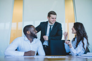 three-co-workers-discussing-in-an-office-setting