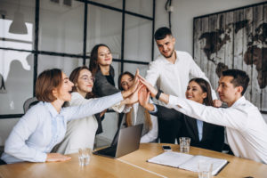 a-group-of-people-joining-hands-together