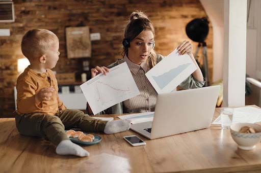 stay-at-home-mother-talking-about-business-reports-during-a video-call-at-home 