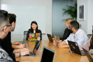 women-in-corporate-setup-smiling-with-coworkers