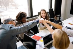 Triumphant-Colleagues-doing-a-Fist-Bump