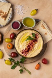 Delicious-hummus-on-plate-still-life-above-view