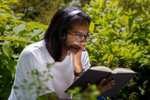 a-lady-with-a-headphone-reading-a-book