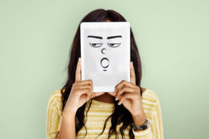 a-lady-covering-her-face-with-a-paper-with-illustration-of-an-emotion