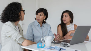 a-group-of-women-discussing-in-the-office