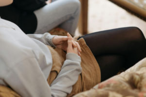 women-crossing-hands-and-sitting-in-anxious-state