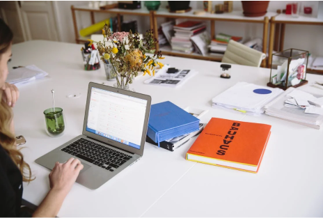 women-working-on-laptop-in-her-arranged-work-station