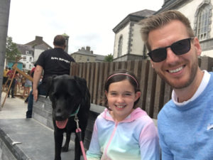 James Kerry with a little girl and his Dog