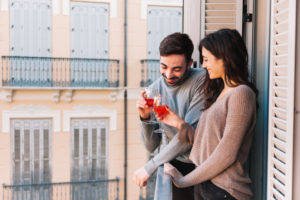 couple-clinking-glasses-in-the-balcony