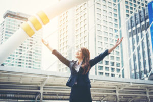 happy-businesswoman-with-hands-raised-up