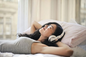 woman-in-gray-tank-top-lying-on-be