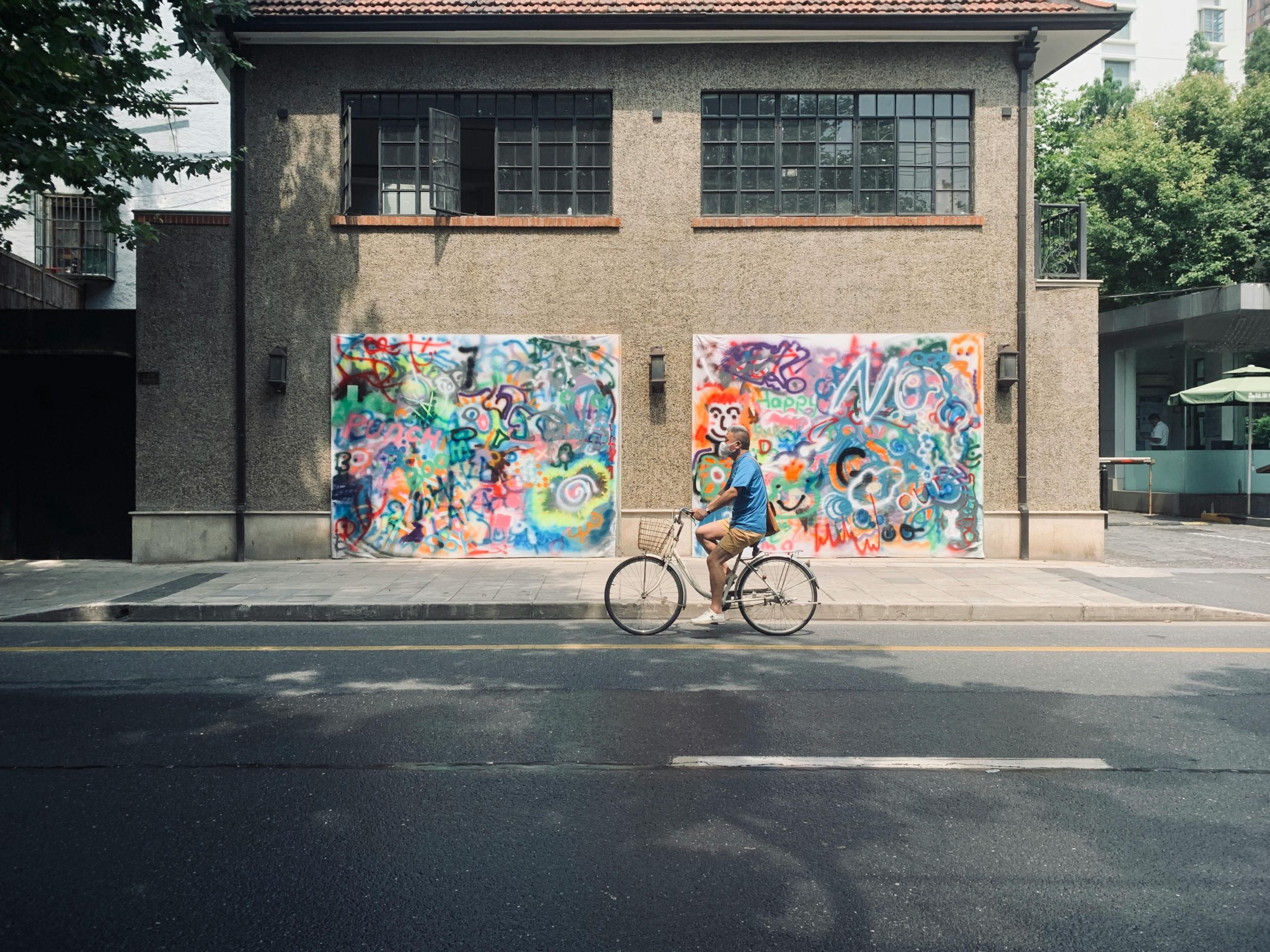 finding creativity in life Man cycling through the road with street art in the background