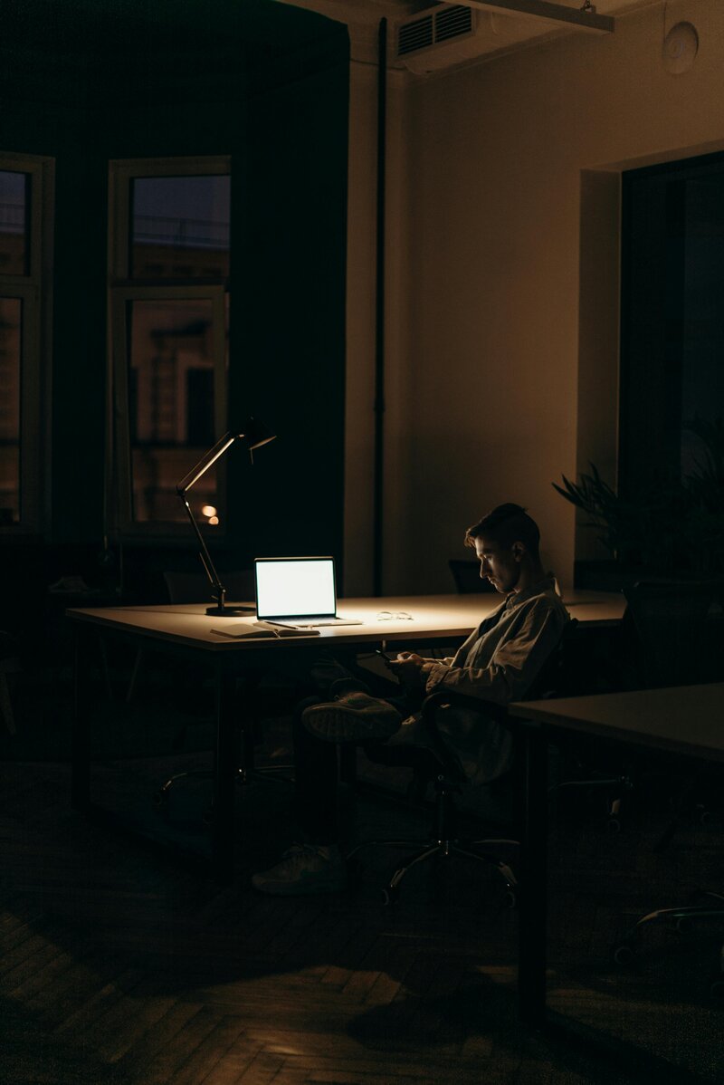 person-sitting-in-a-dark-room-symbolizing-isolation