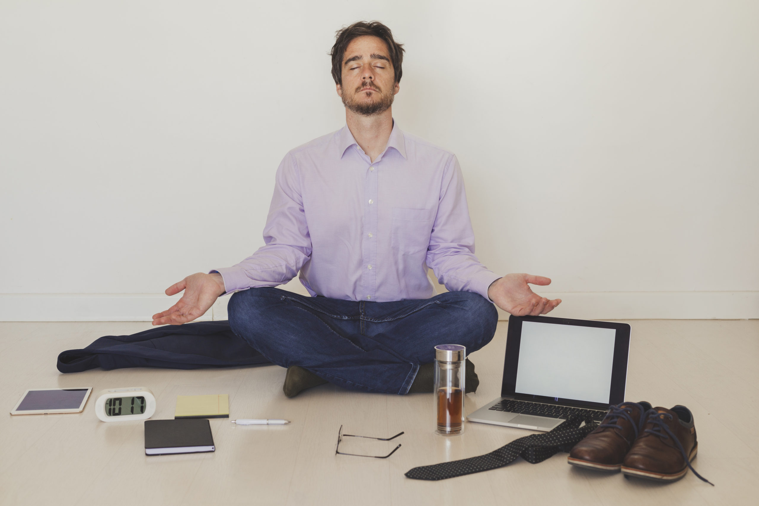 Businessman-meditating-on-floor