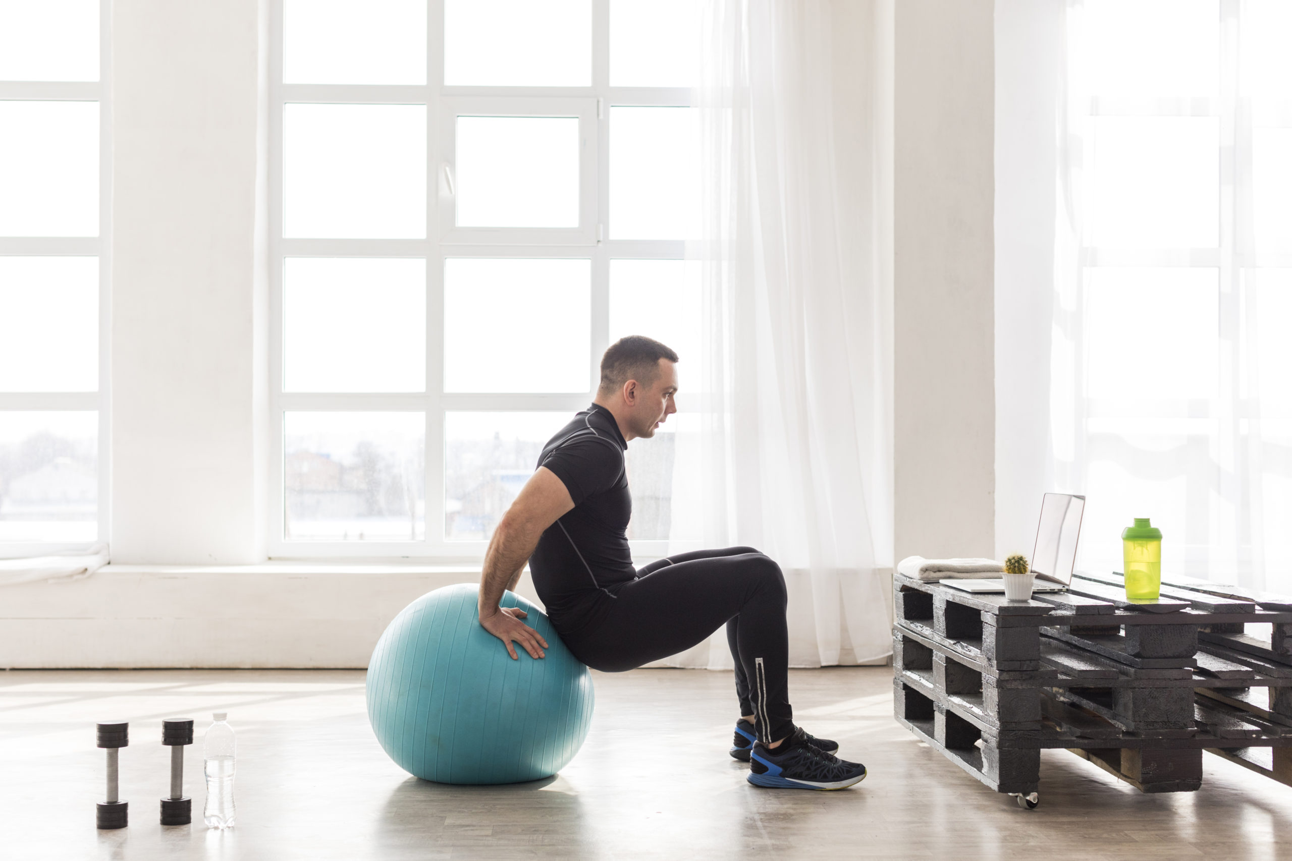 A-person-in-gym-setting-sitting-on-a-stability-ball
