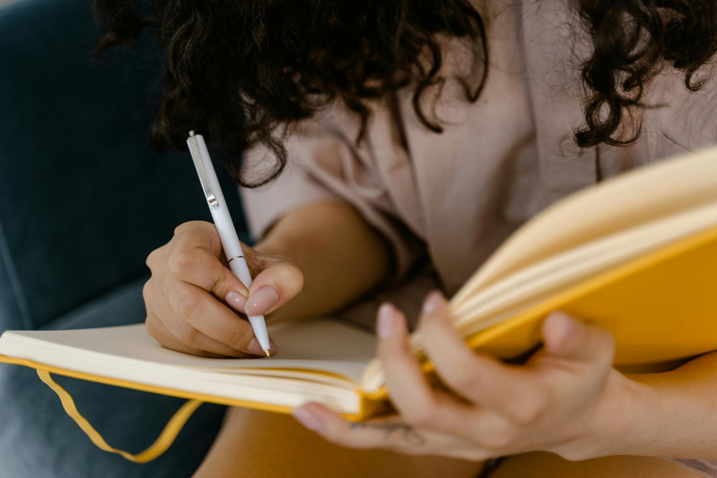 woman-in-white-shirt-writing-on-white-paper