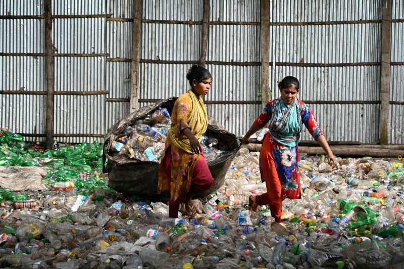  2 women picking up tons of plastic, showcasing the need for zero waste.