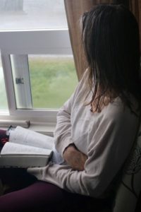 a-girl-reading-by-the-window