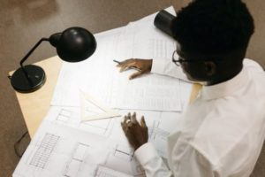 man-working-on-technical-drawings