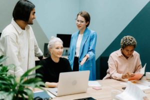 four-people-are-sitting-together-and-discussing-in-office