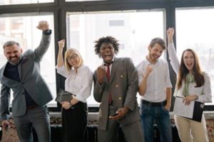 office-team-posing-at-the-camera