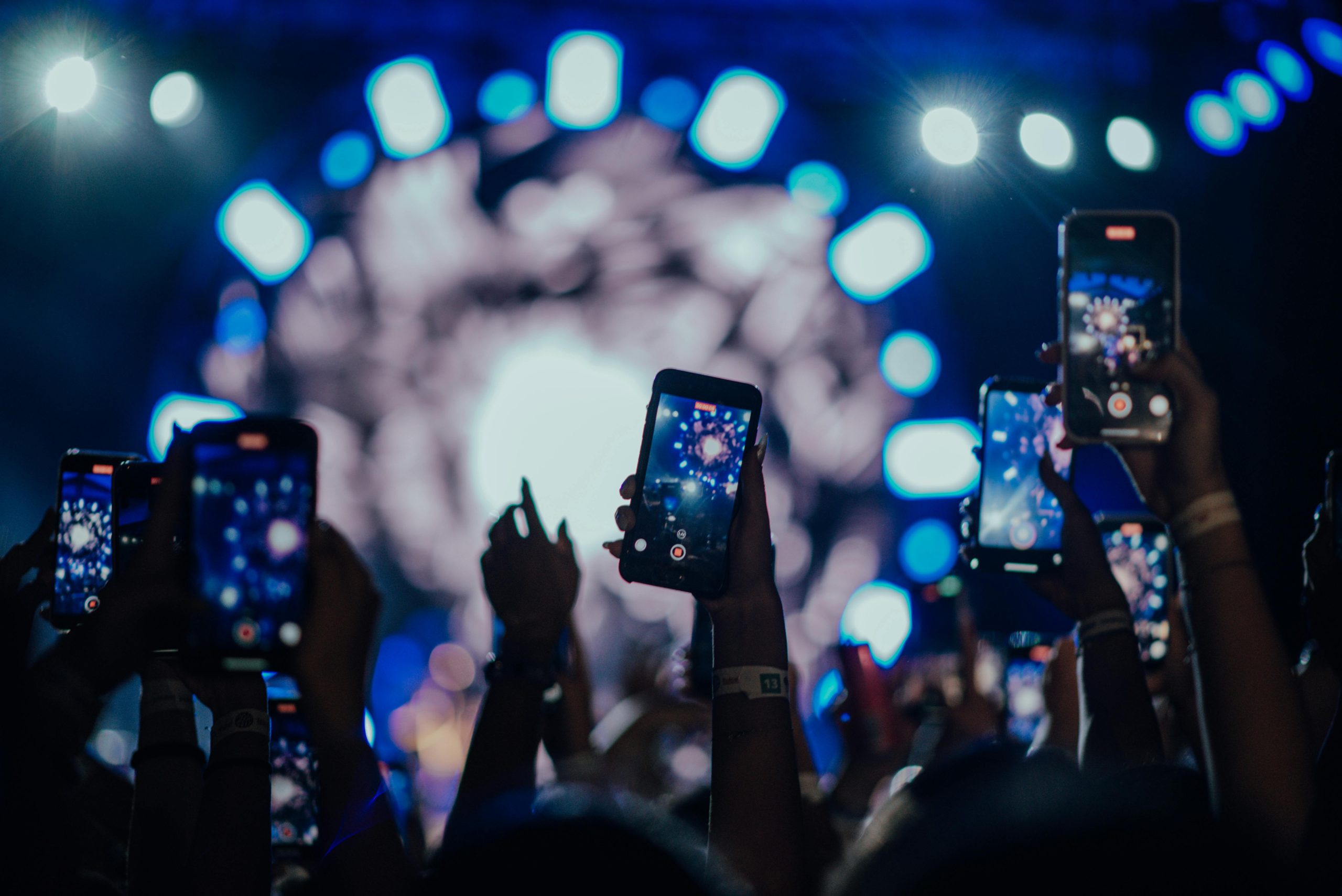 people in a concert with their phones