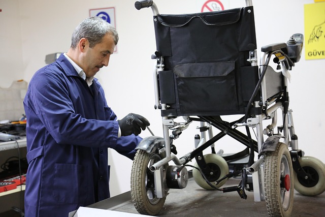 man-fixing-a-wheelchair