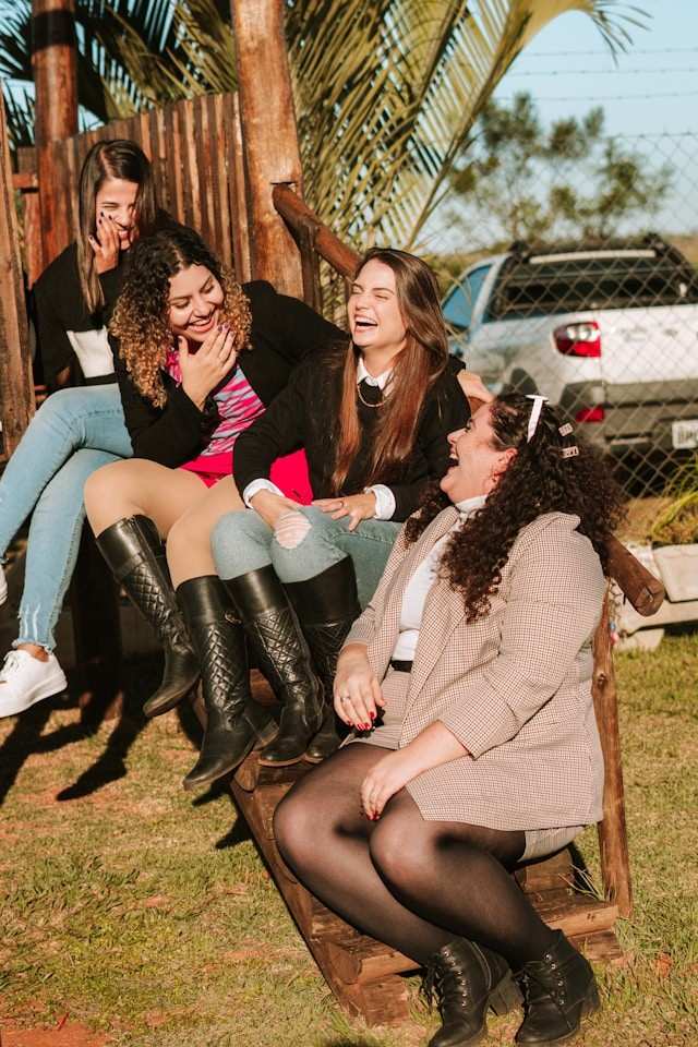 a-group-of-women-sitting-on-a-bench