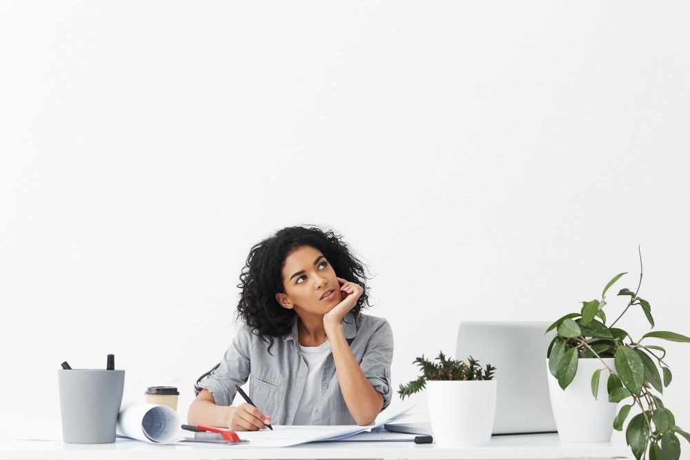 attractive-young-pensive-woman-engineer-wearing-grey-shirt-white-top-looking-up