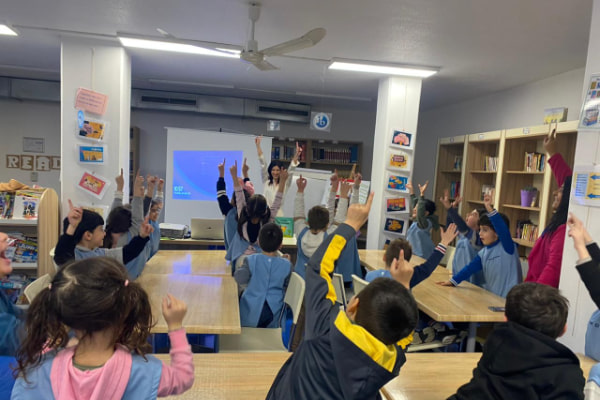 an-image-of-rhea-jabbour-in-a-class-with-a-bunch-of-children