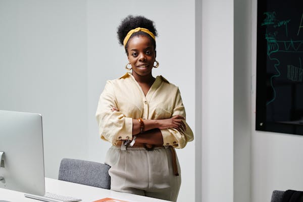woman-in-a-beige-shirt-looking-at-the-camera-while-her-arms-are-crossed