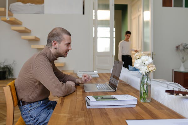 a-man-using-a-laptop-in-a-home-office