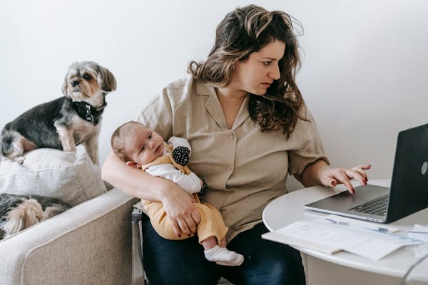 mother-carrying-her-baby-while-working-from-home