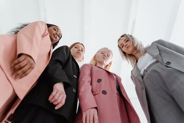 a-low-angle-shot-of-women-wearing-blazers-in-different-colors