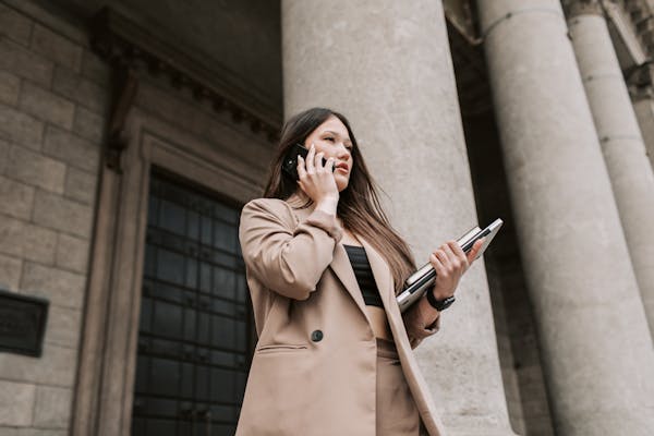 woman-in-beige-coat-making-a-phone-call