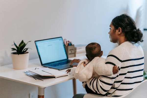 mother-carrying-her-baby-while-working-from-home
