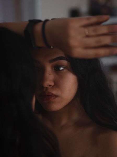 woman-looking-at-reflection-in-mirror