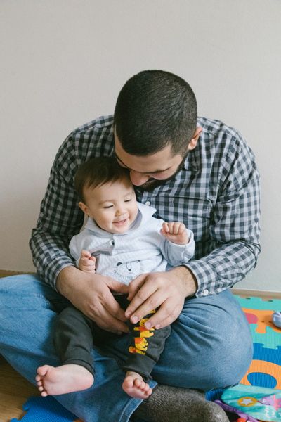 child-sitting-on-father-s-lap