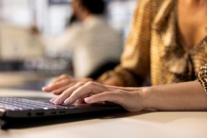 Professional working on a laptop, reflecting career growth and the confidence gap in the workplace.