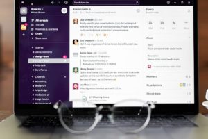 Laptop screen showing workplace messages and team communication visibility.
