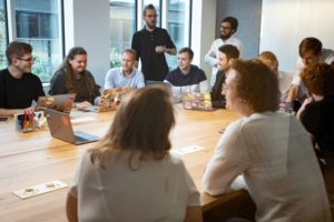 A diverse and inclusive team working together, representing what genuine corporate allyship looks like beyond rainbow branding and seasonal campaigns 