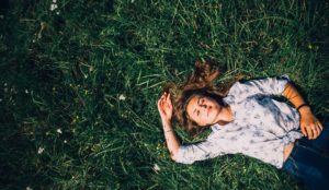 woman-lying-grass-to-clock-out