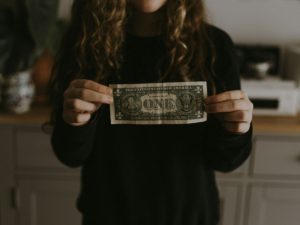 A woman holding a note in her hand