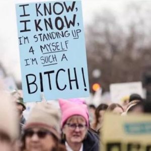 Protester holds a sign reading, “I’m standing up for myself. I’m such a bitch,” during a women’s demonstration.