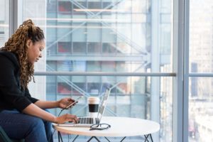 A woman sitting alone and working on laptop